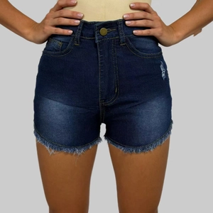 Close-up of high-waist dark blue denim shorts with distressed frayed hem and whiskering