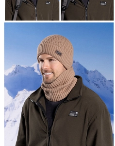 Close-up of khaki winter knit hat and neck warmer set worn in snowy mountains