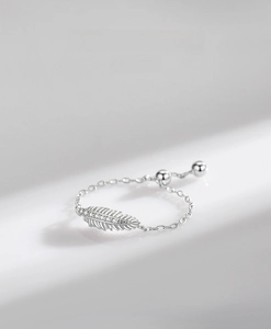 Detailed macro view of S925 sterling silver feather ring with micropave zircon stones
