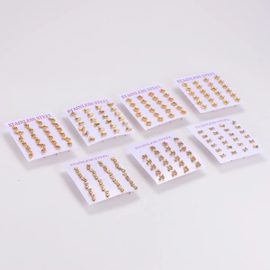 Collection of minimalist gold stainless steel stud earrings featuring musical notes and stars