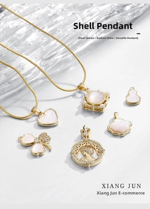 Detailed view of 18k gold plated butterfly and shell pendants for DIY jewelry making