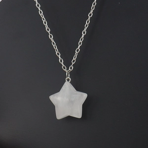 Macro shot of 2.5cm star-shaped natural crystal pendant on silver metal chain