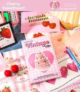 Detailed view of vintage postcard set featuring pink sweet cherry and cat illustrations