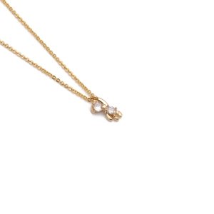 Gold plated bear necklace featuring a dual stone pendant with sparkling clear crystals