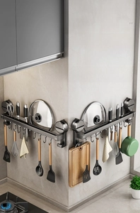 Wall-mounted suction cup kitchen rack showing corner storage with pot lids and knives