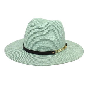 Detail of mint green straw fedora hat featuring a black band with gold chain and studs
