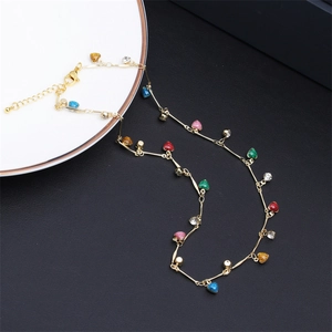 Close-up of gold chain necklace with colorful heart charms and adjustable lobster clasp