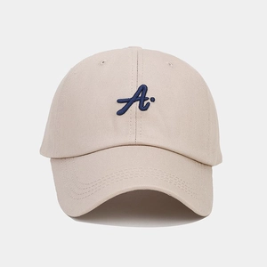 Detail of navy blue embroidered letter A on beige cotton twill baseball cap