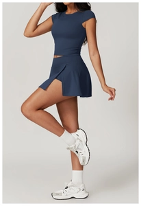 Detail of navy blue high-waist sports skirt and compression short sleeve workout set