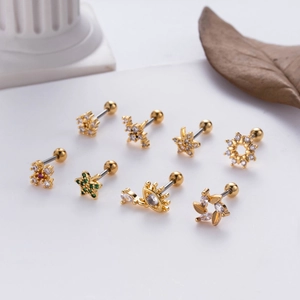 Golden flower and star zircon ear studs with screw ball backs set on minimalist decor