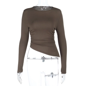 Detail of long sleeve slim top featuring brown asymmetric hem and side ruching texture