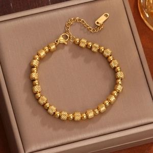 18K gold plated titanium bracelet with textured beads shown at a 45-degree angle