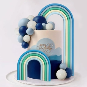 Blue rainbow arch and mixed sphere cake toppers with a Happy Birthday round plaque