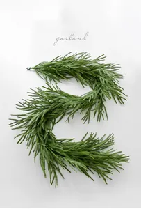Close-up of flexible green Norfolk pine garland for holiday mantle and table decoration
