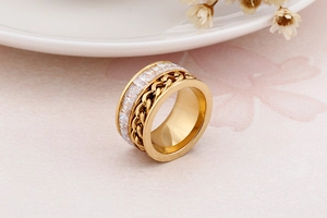 Detailed macro shot of gold-plated chain ring with square-cut cubic zirconia inlays