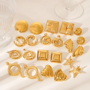 Flat lay of 18K gold plated stainless steel earrings with geometric heart and snake designs