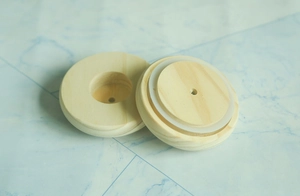Detail view of round wooden base with silicone ring for DIY crafts and glass dome
