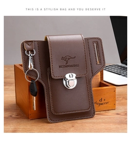 Detailed view of brown leather phone belt pouch with key hook and buckle on wooden desk