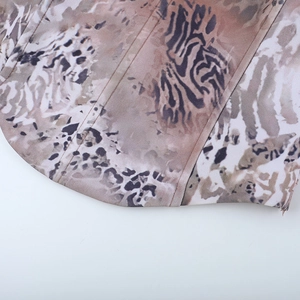 Detail shot of leopard print corset showing precise stitching and fabric texture