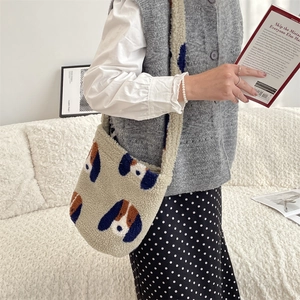 Detailed close-up of fluffy cream lamb wool bucket bag with cute dog pattern embroidery