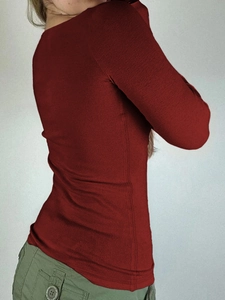 Detailed side view of a red long-sleeved Y2K button shirt showing the slim fit on a model