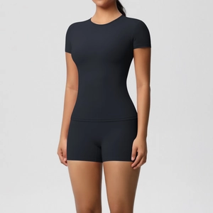 Close-up of black tight-fit yoga set with short-sleeve top and high-stretch fitness shorts