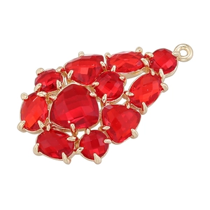 Close-up of gold grape-shaped leaf pendant with sparkling faceted red glass gems