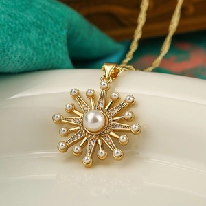 Elegant gold sunflower pendant necklace with central pearl and sparkling zircon accents