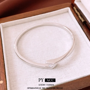 Silver plated bangle featuring a sparkling cubic zirconia stone in a minimalist metal design