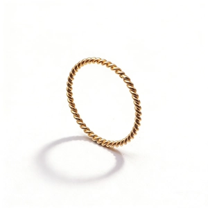 Macro shot of gold twisted rope ring showing delicate metallic details and texture