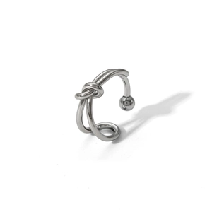 Detailed close-up of a silver knot ring with dual lines and sphere accents