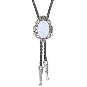 Detailed view of silver crown bolo tie with white crackle stone and braided leather cord