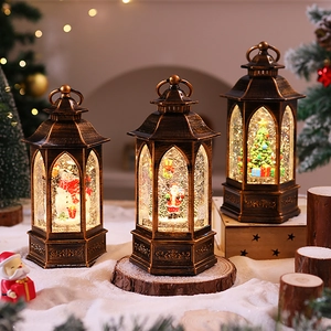 Close-up of three bronze vintage Christmas lanterns with Santa, Snowman and Tree figures