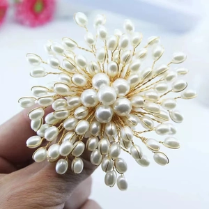 Macro shot of handcrafted luxury snowflake pearl brooch with golden wire detailing