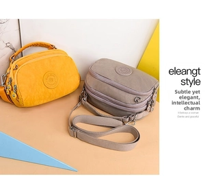 Detail of yellow and khaki nylon crossbody bags with triple zipper pockets and straps