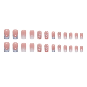 Sparkly pink gradient press-on nails with silver French tips, hearts and tiny rhinestones