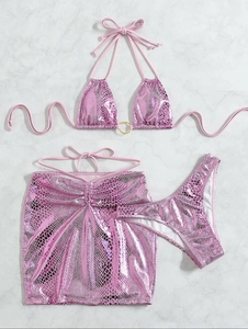 Flat lay of pink snakeskin bikini set with metallic finish and gold ring details
