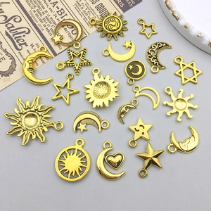 Macro shot of celestial alloy charms with sun moon stars in antique gold finish