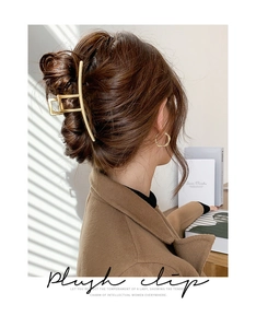 Matte gold rectangular hair claw clip worn by model for elegant summer hairstyles