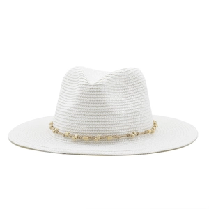 Detail of white woven straw fedora featuring hemp rope band and natural wood bead accents