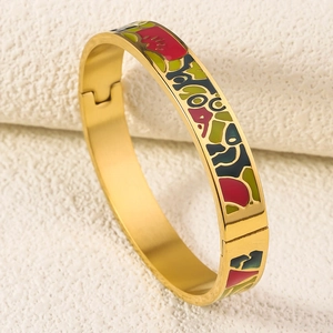 Detailed macro view of 18K gold plated bangle with colorful enamel inlay patterns
