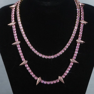 Close-up of 5mm pink tennis chain with spike pendant on a black velvet mannequin