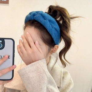 Chunky knit royal blue twisted headband for women showing high top hair styling look