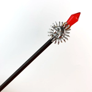 Detailed view of moon and star silver ornament with red crystal on black wood hair stick