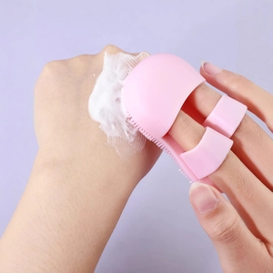 Pink silicone finger cleansing brush with soft bristles for pore and nose wing cleaning