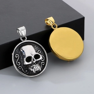 Detailed view of skull pendant with antique silver relief and smooth golden back finish