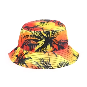 Detail of yellow-red gradient sun hat with black palm tree prints and metal eyelets