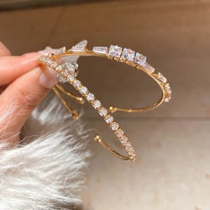 Detail of 18K gold plated open cuff with rectangular and square cubic zirconia stones