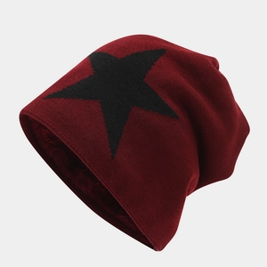 Macro detail of the thick fleece lining inside the burgundy star knit beanie hat