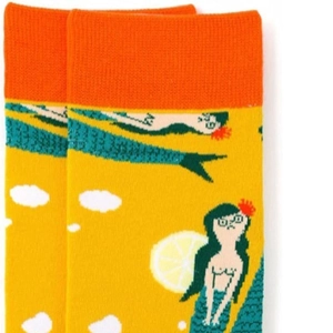 Close-up of cotton socks with orange ribbed cuffs and mermaid illustration